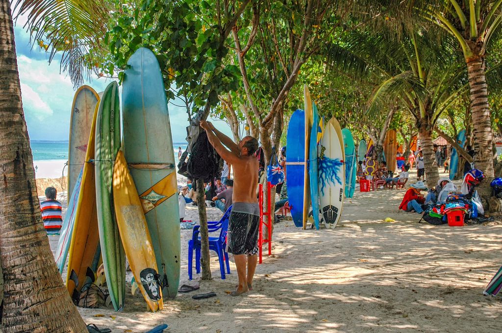 Surfboards and people at a beach in Bali, Indonesia.
