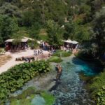 Blue Eye spring in Albania surrounded by trees.