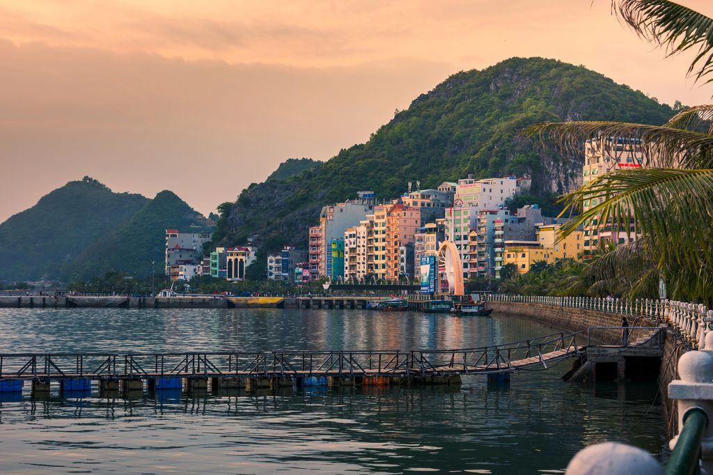 Bridge on the bay with a hill and buildings in the background in Cat Ba, Vietnam.