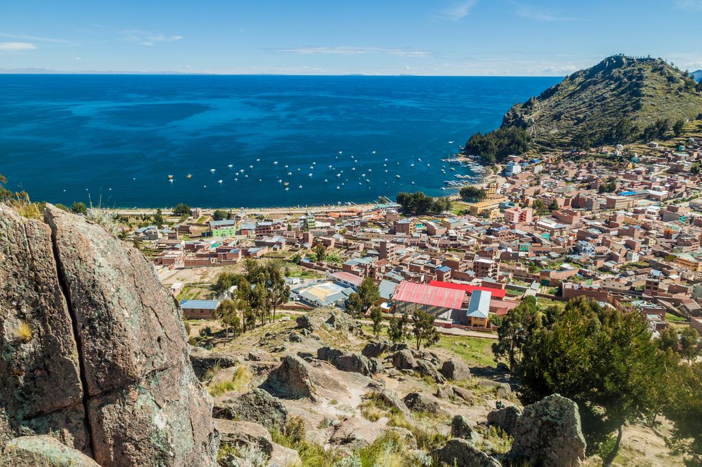 A high-angle view of Copacabana, Bolivia, showing the town nestled along the shores of Lake Titicaca.