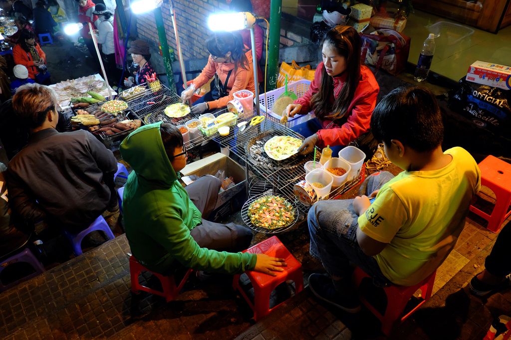 People eating at a night market in Dalat, Vietnam.