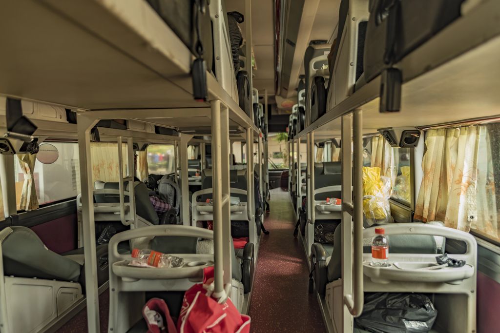 The interior of a sleeping bus in Dalat, Vietnam with reclining seats.