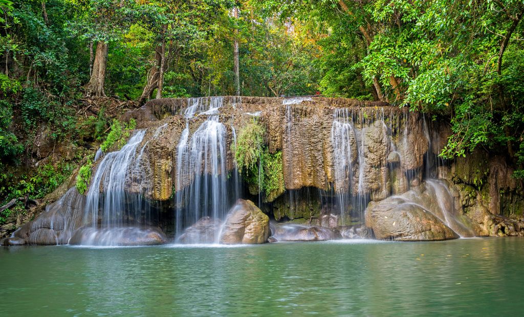 A waterfall cascading in Kanchanaburi, Thailand.