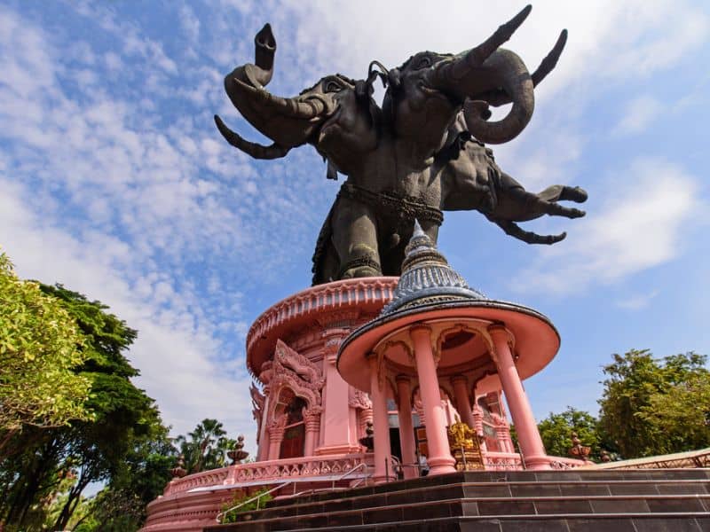 A statue on a pink building in Bangkok, Thailand.