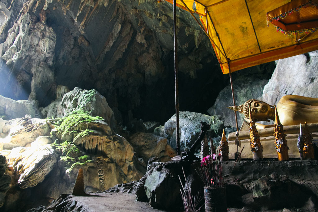 A cave with a Buddha statue in Laos.