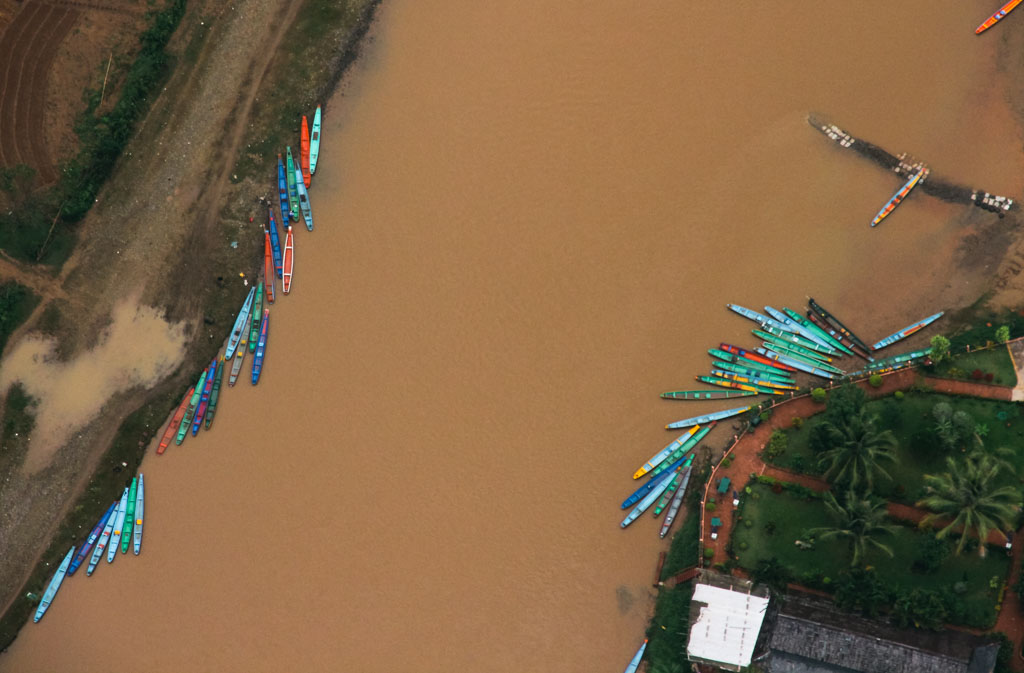 An aerial view of a river in Laos with boats.