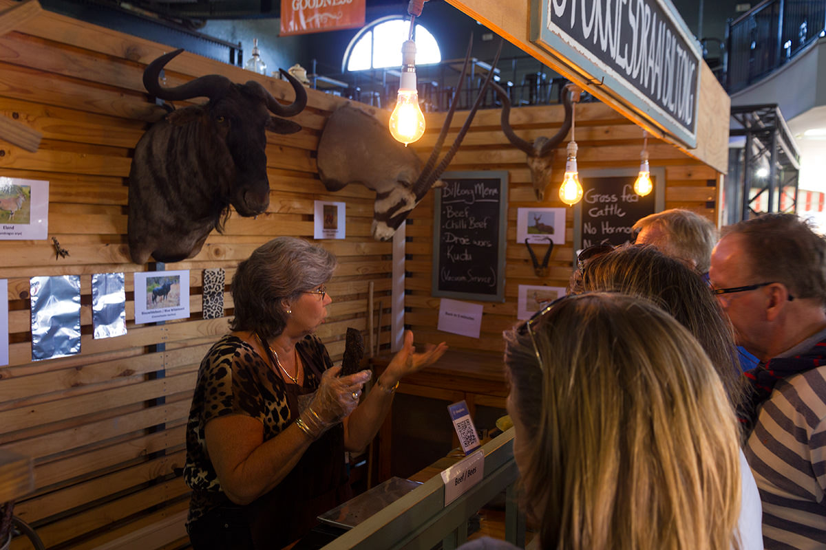 Woman selling ostrich and game meat at the V&A food market in Cape Town