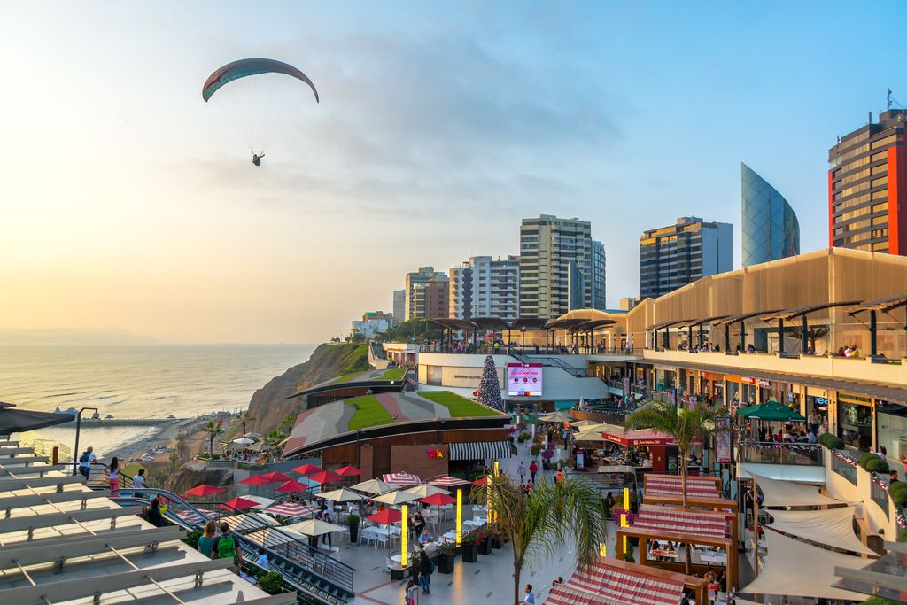 A person paragliding above the city of Lima, Peru