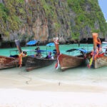 Longtail boats on tropical beach