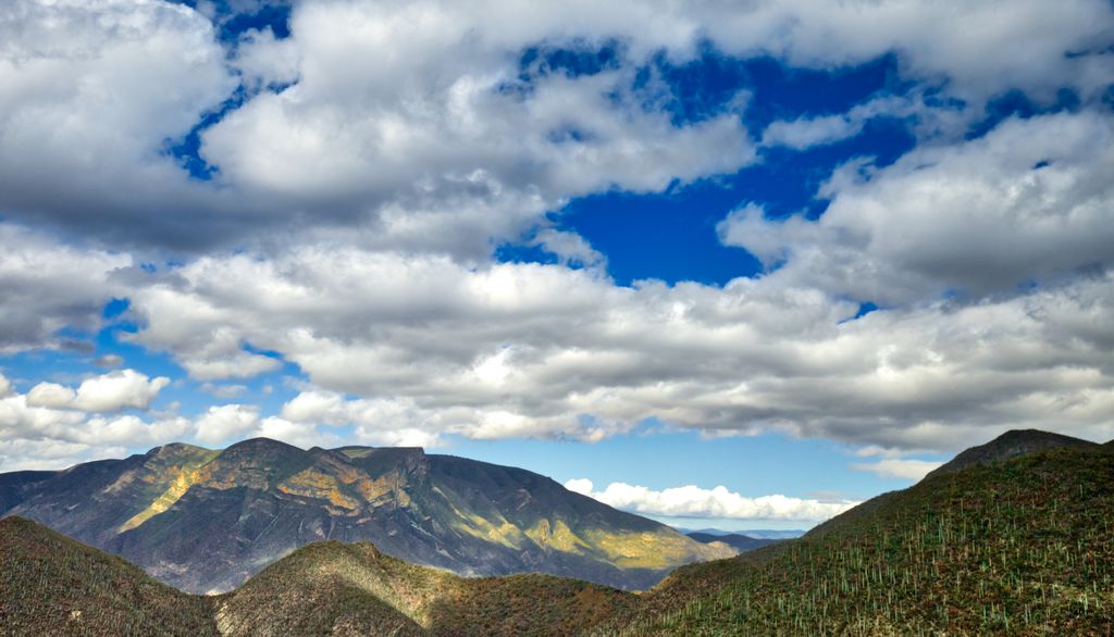 Mountains between Mexico City and Oaxaca City under the blue sky with clouds.