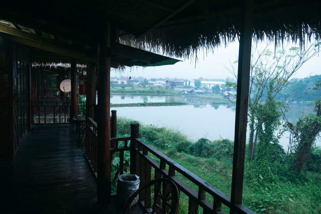 A guesthouse in Luang Namtha, Laos with a body of water outside it.
