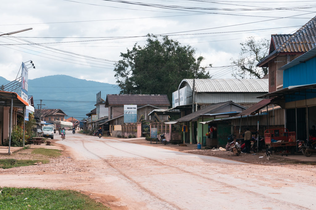 A road in Luang Namtha, Laos with a mountain in the background.