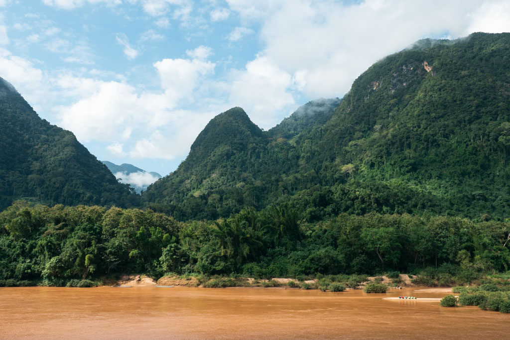 Yellow-brown river surrounded by mountains.