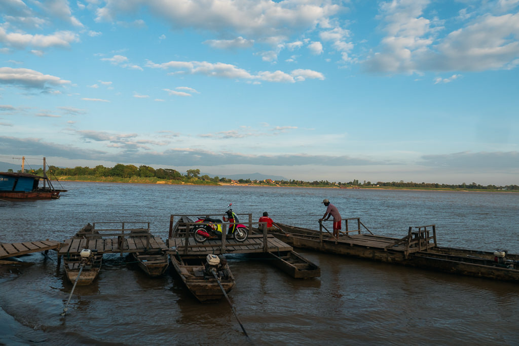 Men and wooden boats on a small pier.