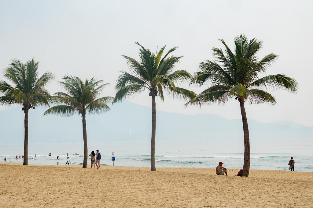 My Khe Beach with people and palm trees.