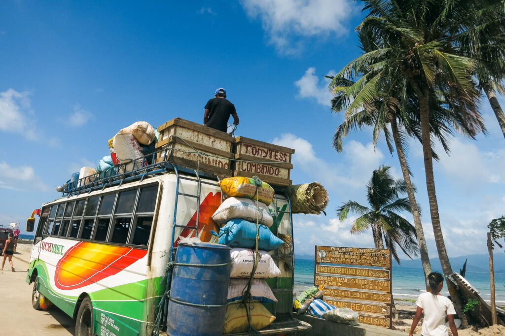 A bus in Palawan, Philippines, loaded with goods strapped to its roof and sides
