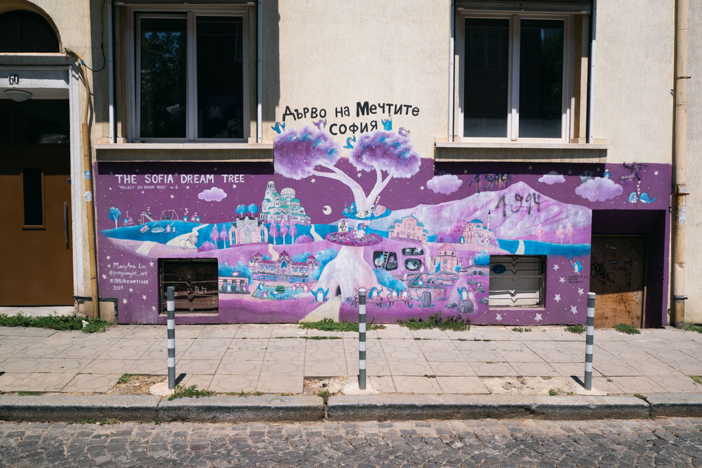 Purple street art on a building in Sofia, Bulgaria.