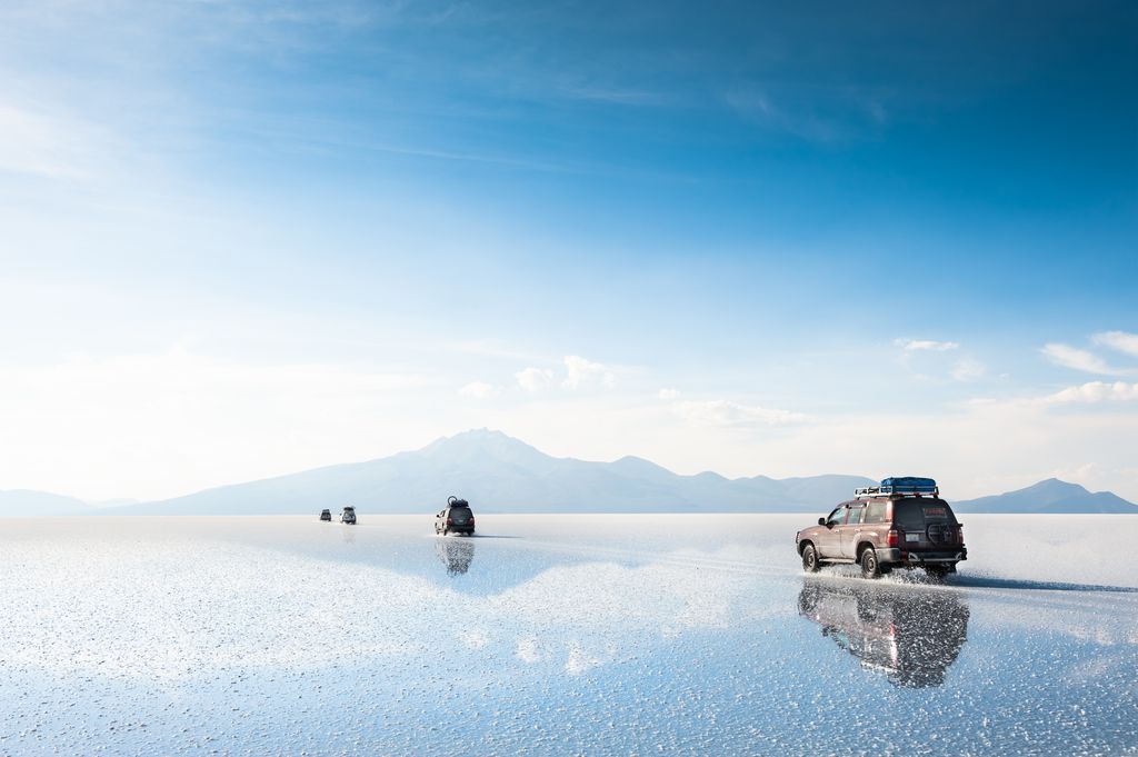 SUVs cruising across the Salar de Uyuni