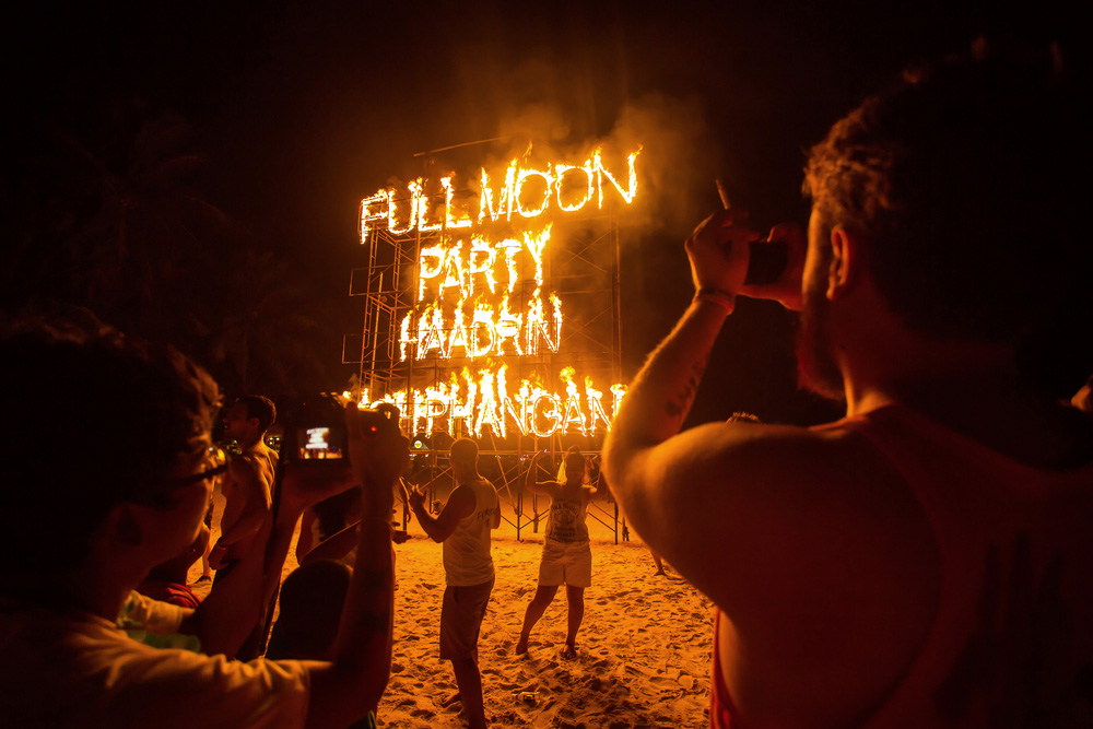 People partying on the beach at night in Thailand.