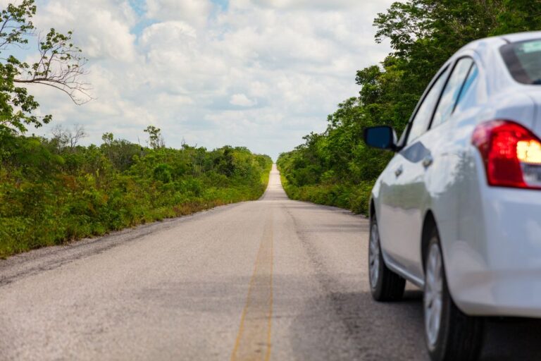 A car on a Yucatan road trip in Mexico